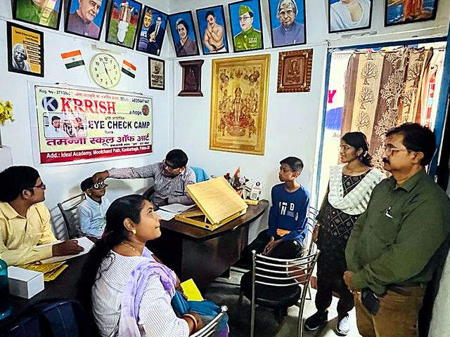 Teacher singing with students beside a tabla player