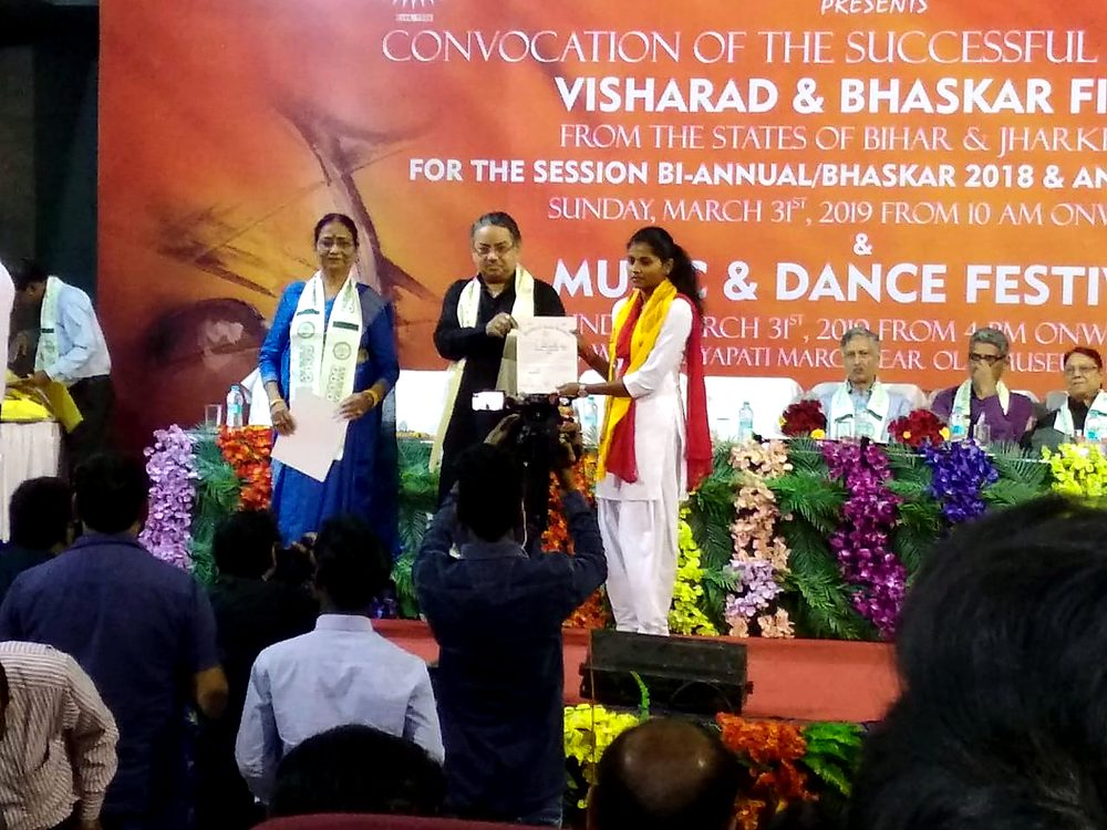 A student receiving her certificate at the annual convocation